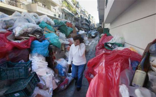 A Woman in Athens A Woman in Athens, Greece walks by un-collected garbage due to a public workers strike: October 19, 2011